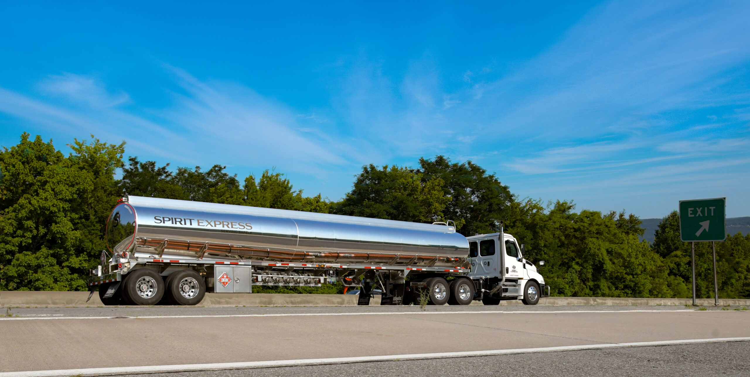 SE Tanker truck on highway with bright blue sky